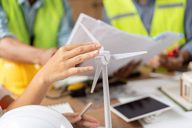 istock Sustainable Engineering Collaboration. Professionals examining wind turbine models for renewable energy projects. 2219765944