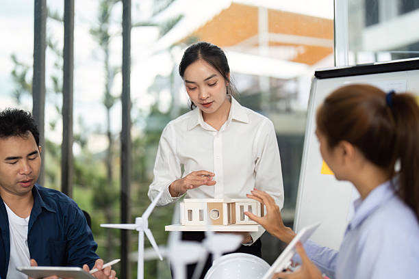 istock Innovative Architecture Discussion. Female engineer explaining sustainable design to a team. 2219767921