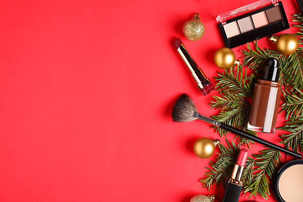 istock Flat lay composition with makeup products and Christmas decor on red background, space for text 2219768713