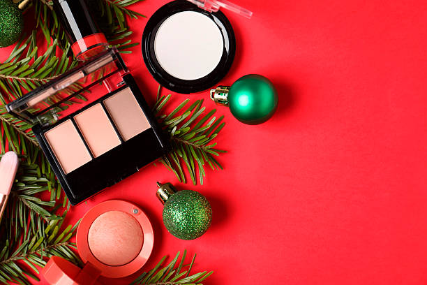 istock Flat lay composition with makeup products and Christmas decor on red background, space for text 2219768715