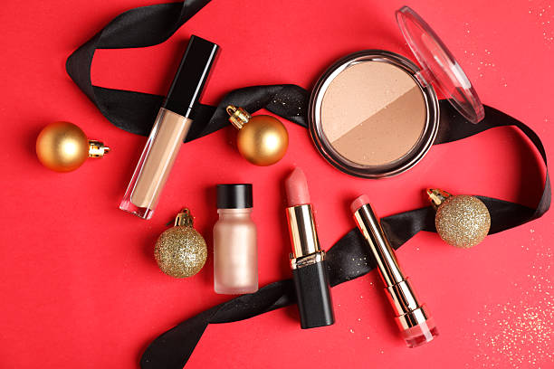 istock Flat lay composition with makeup products and Christmas decor on red background 2219768720