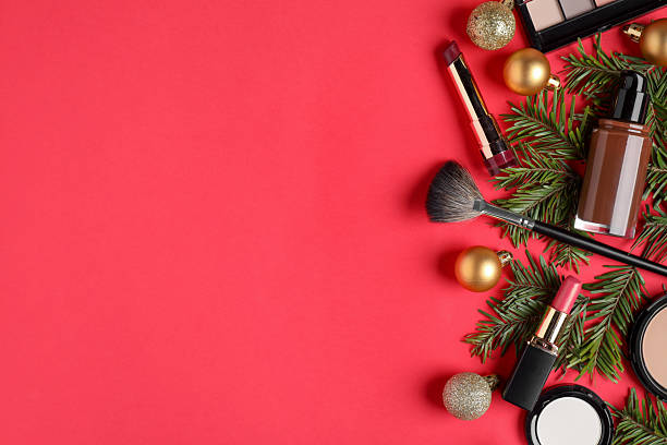 istock Flat lay composition with makeup products and Christmas decor on red background, space for text 2219768759
