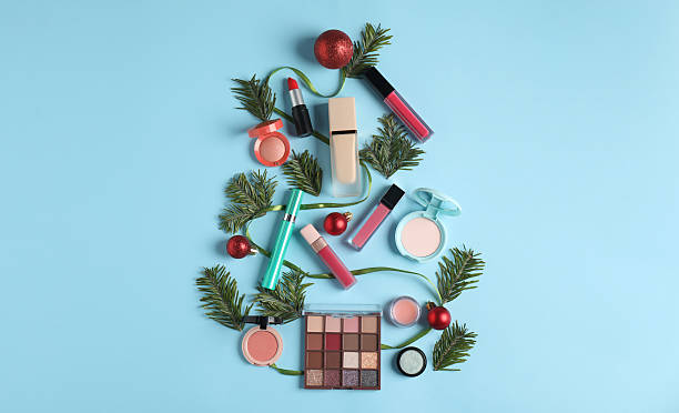 istock Christmas tree made with makeup products and decor on light blue background, flat lay 2219768780