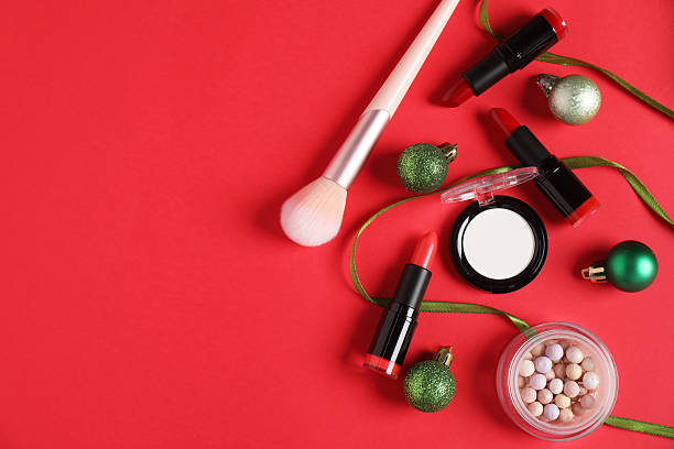 istock Flat lay composition with makeup products and Christmas decor on red background, space for text 2219768792