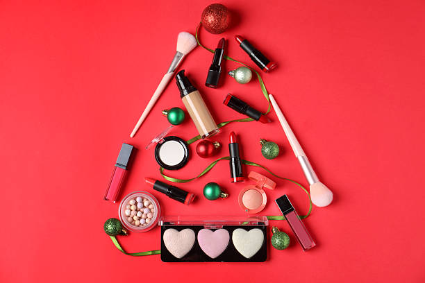 istock Christmas tree made with makeup products and decor on red background, flat lay 2219768793