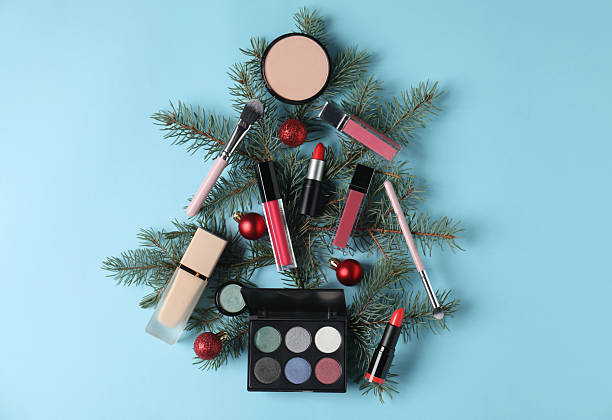 istock Christmas tree made with makeup products and decor on light blue background, flat lay 2219768801