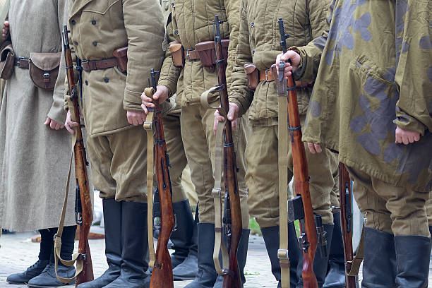istock Mens dressed as Soviet infantrymen of the Second World War hold rifles in their hands 2219769076
