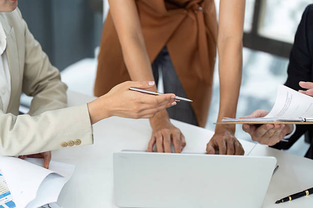 istock Collaborative Meeting. Professionals discussing over documents and laptop. 2219769203