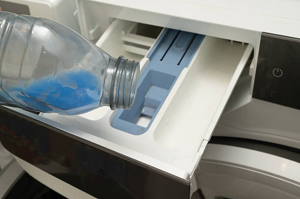 istock A vibrant blue liquid is poured into a washing machine for laundry 2219769672