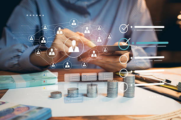 istock financial analysis. Digital Financial Analysis with Coins and Graphs Depicting User Connections in Modern Workspace Setting 2219772443