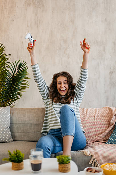 istock Young Woman Playing Video Games On A Joystick At Home 2219773181