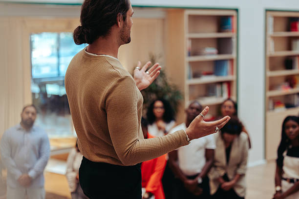 istock Internal meeting in a modern office setting with a speaker addressing a diverse team 2219774703
