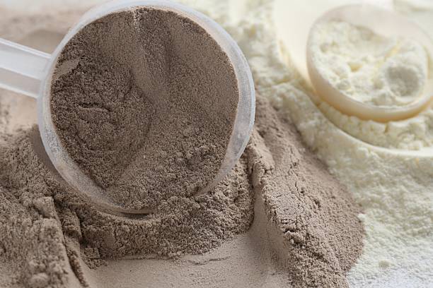 istock Pile of protein powders and scoops, closeup 2219776189