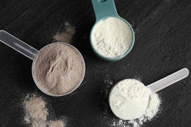 istock Protein powders in scoops on grey textured table, flat lay 2219776213
