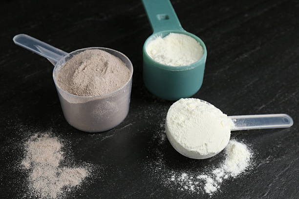 istock Protein powders in scoops on dark textured table 2219776233