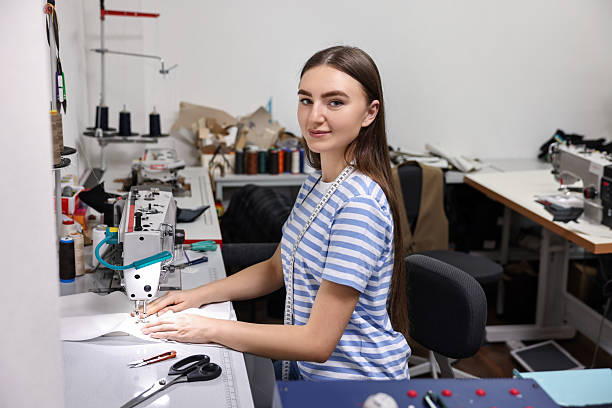 istock Young woman working with sewing machine in professional workshop 2219776998
