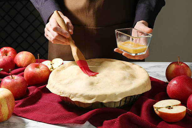 istock Woman making homemade apple pie at white marble table, closeup 2219777332
