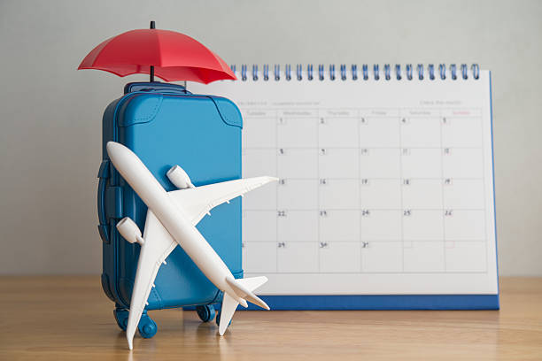 istock Airplane, suitcase, umbrella and blank white calendar. 2219778507