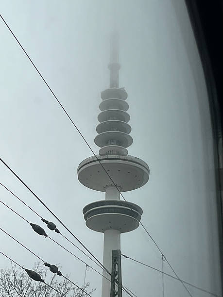 Misty view of the Heinrich-Hertz-Tower from a passing train window.