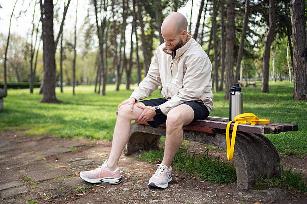 istock Man resting on park bench after outdoor workout session 2219783737