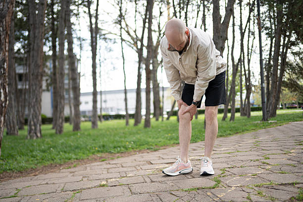 istock Bald man in park experiencing knee pain during outdoor exercise 2219783809