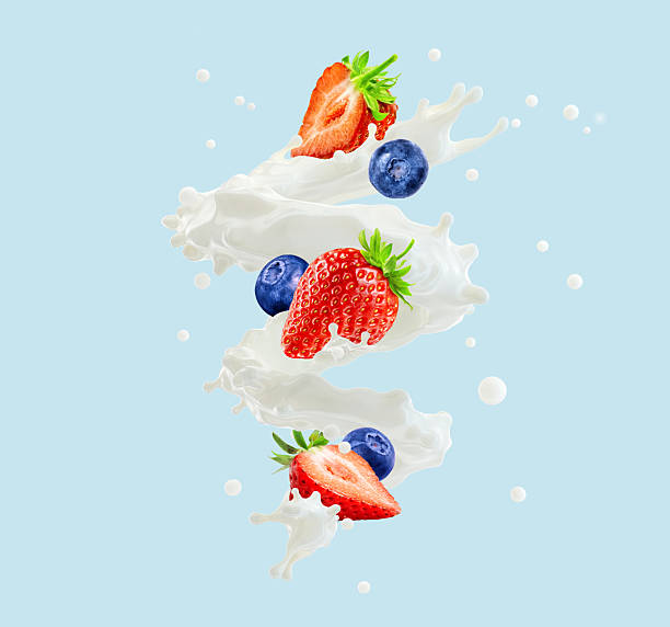 istock Strawberries, blueberries, milk, cream or yogurt splash isolated on blue background. 2219786580