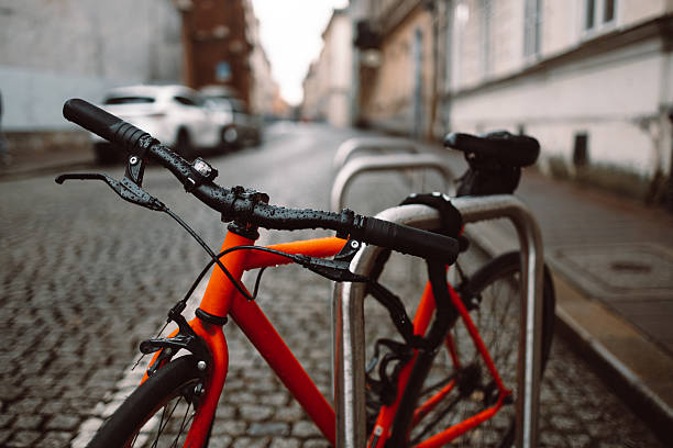Orange bicycle stands on the orange bicycle park. High quality photo