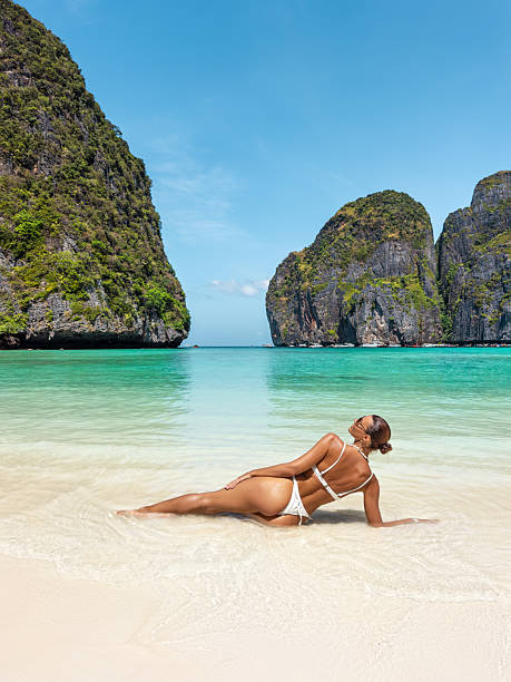 istock Woman in White Bikini Relaxing on the Shore at Maya Bay, Phi Phi Islands, Thailand 2219790914