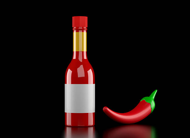 Hot Sauce Bottle With Empty Label And Red Chili Pepper On Black Background