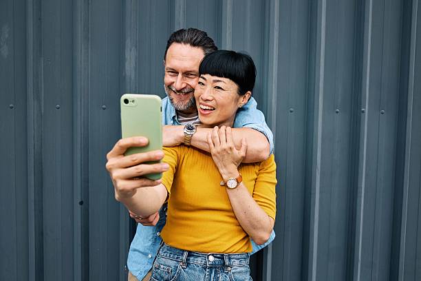 istock Romantic middle aged couple hugging and making selfies outdoors. 2219793036