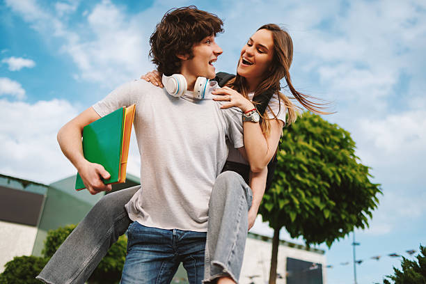 istock Happy students piggybacking outdoors having fun after school 2219794912
