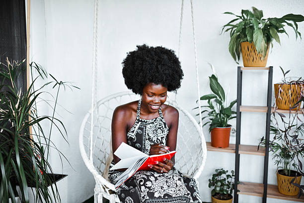 istock Happy Lady Outdoors on Swing Smiling Brightly While Doing Her Morning Journaling 2219797875