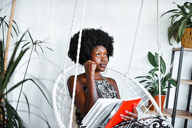 istock Female Writing in Notebook Lost in Her Thoughts While Organizing Monthly Finances 2219797978