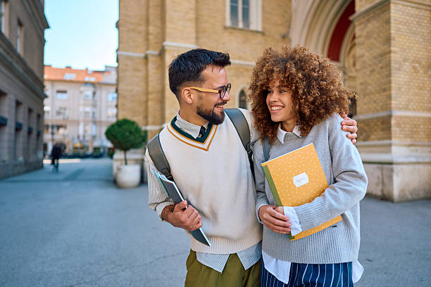 istock Two happy students walking together on campus 2219801296