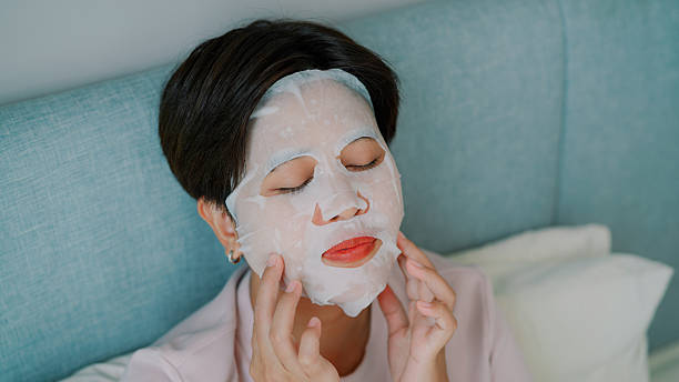 istock Asian woman sleeping on bed while using facial mask 2219802116