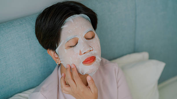 istock Asian woman sleeping on bed while using facial mask 2219802172