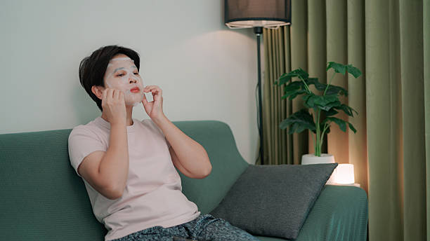 istock Asian woman using facial mask 2219802534