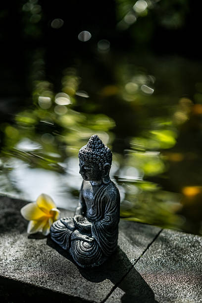 istock Peaceful Buddha statue near koi pond meditation scene 2219809953