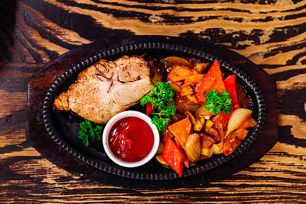 steak with vegetables and sauce. tasty dish. top view