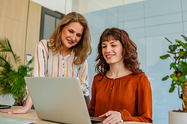 istock Businesswomen collaborate in a modern office environment using technology for effective teamwork and productivity 2219810997