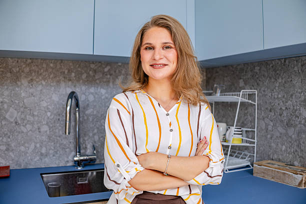 istock Businesswoman stands confidently in modern office kitchen while managing daily tasks and interactions with colleagues 2219813377