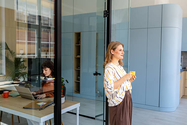 istock Businesswomen collaborating in a modern office environment during a productive workday 2219813820