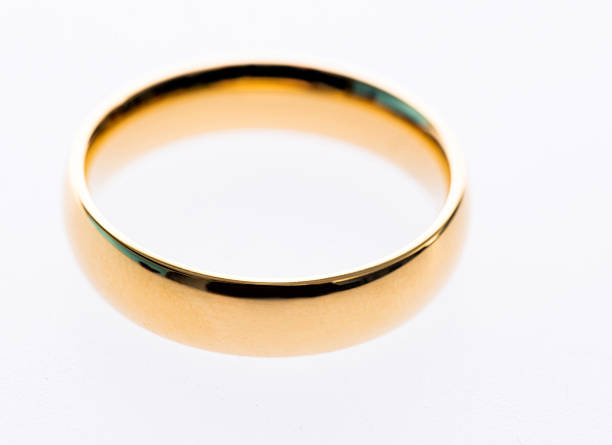 istock Single golden wedding rings on white background 2219813835