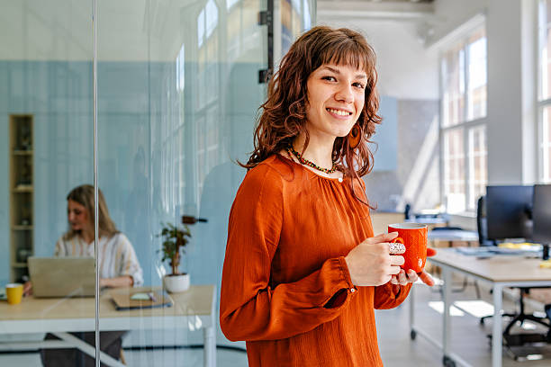 istock Businesswomen collaborating in a modern office environment while enjoying coffee during a productive workday 2219814050