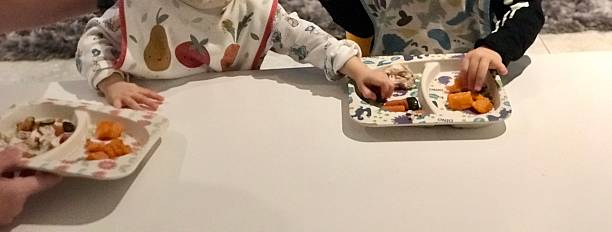 istock Toddler hands and plates 2219814108