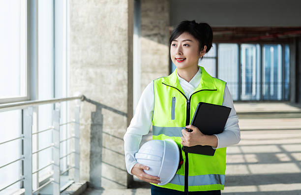 istock Female construction worker holding digital tablet on construction site 2219814225