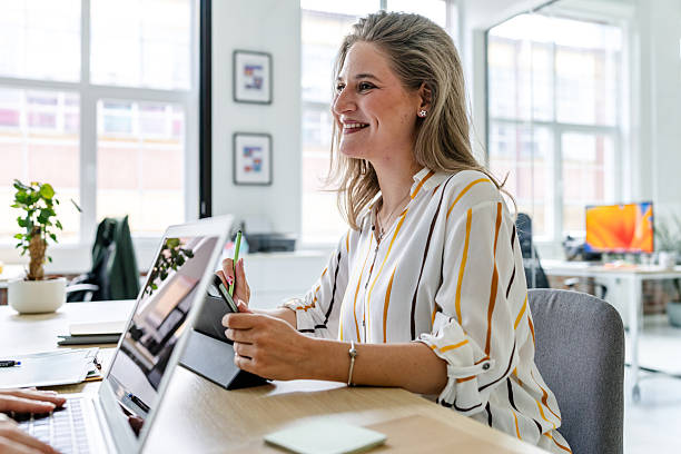 istock Businesswomen collaborating in a modern office space while discussing innovative ideas and strategies 2219814871