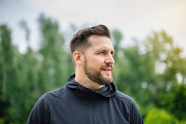 istock Confident athlete looking away while standing in a park 2219814936