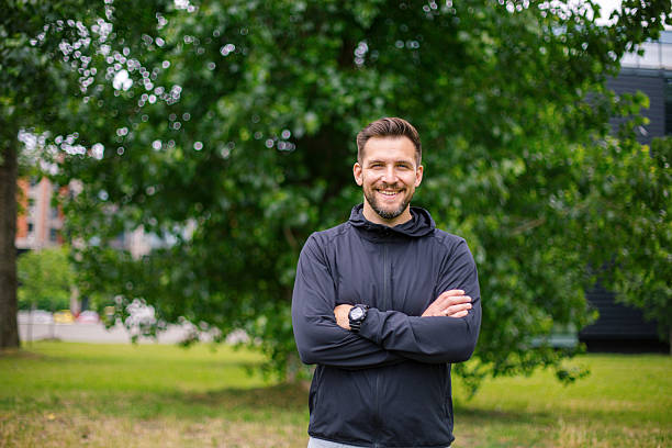 istock Confident male athlete smiling at the camera in a park 2219816569
