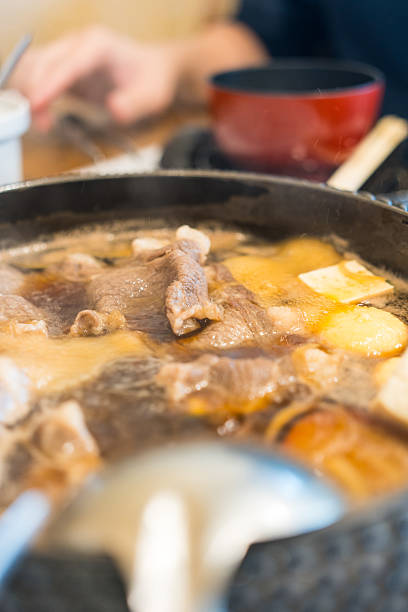 istock Boiling Shabu soup base in hot pot that fill with beef ready for eating 2219817449
